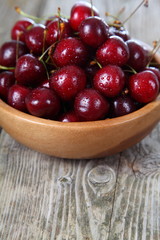 Ripe cherry in a wooden bowl