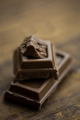 Pieces of chocolate on a wooden table