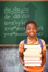 Composite image of cute little boy carrying books in library