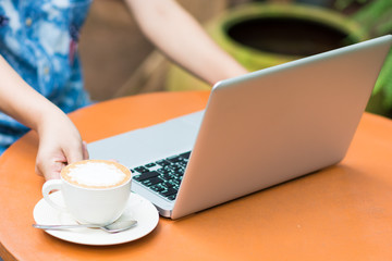 Woman hands typing on laptop