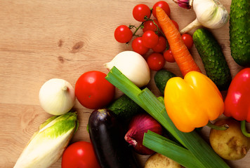 Composition with assorted raw organic vegetables wooden table