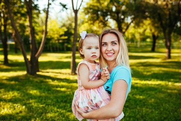 Fototapeta premium Happy mom and daughter smiling at nature.