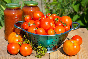 Fresh tomatoes and homemade tomato juice on the wooden table
