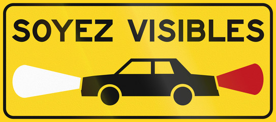 Warning road sign in Quebec, Canada - Turn on lights. Soyez visibles means be visible