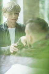 Psychiatrist comforting military patient