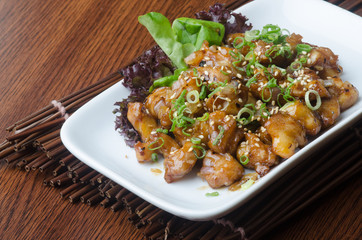 japanese cuisine. fry sauce chicken on the background