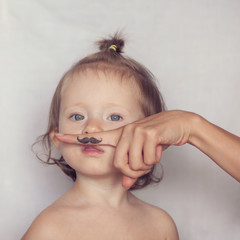 toddler posing with funny hipster mustache
