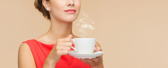 smiling woman in red dress with cup of coffee