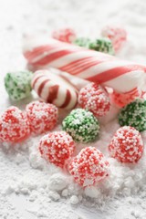 Fototapeta na wymiar Christmas bonbons and candy canes in icing sugar