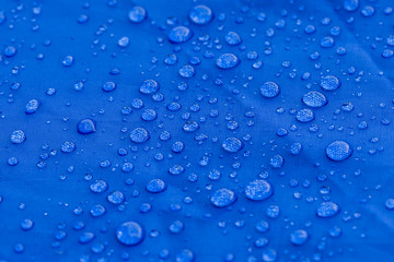 Raindrops on the surface of blue tent