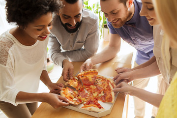 happy business team eating pizza in office