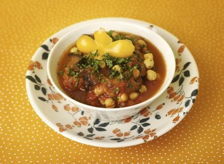 Chick-pea stew with potatoes in soup bowl