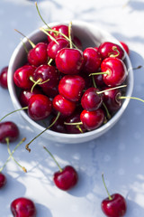 Obraz na płótnie Canvas Sweet cherries in the bowl, on the garden table.