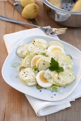 Potato Salad with Sliced Boiled Egg In Wood Bowls