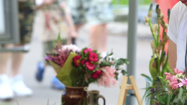 Woman florist making a bouquet on the street.