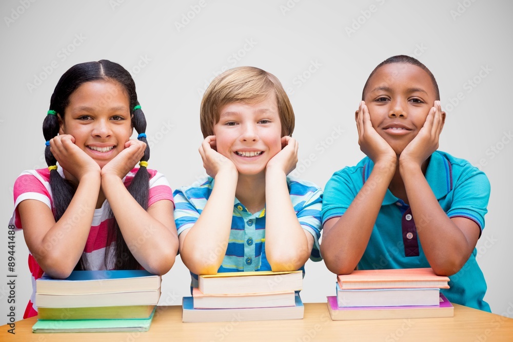 Poster composite image of cute pupils looking at camera in library