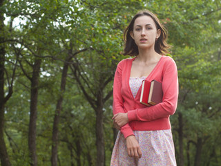 A young girl holding a book.