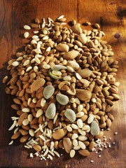 Shelled & unshelled almonds & slivered almonds on wooden background
