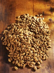 Shelled almonds on wooden background