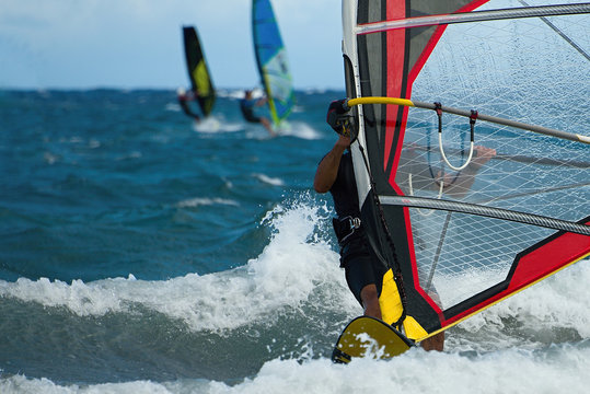 Three windsurfers in action