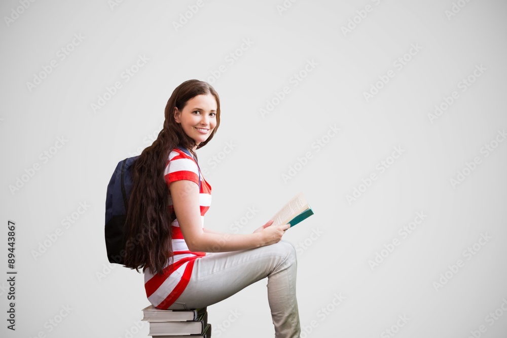 Poster composite image of student reading book in library