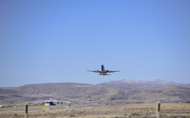 Fototapeta na wymiar Plane taking off at the airport in San Carlos de Bariloche, Patagonia, Argentina.