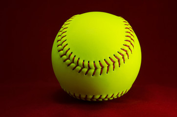 Softball on a red background