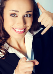 Businesswoman with call me gesture