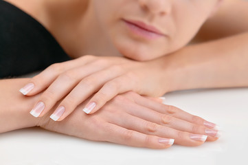 Young beauty with polished finger nails, relaxed