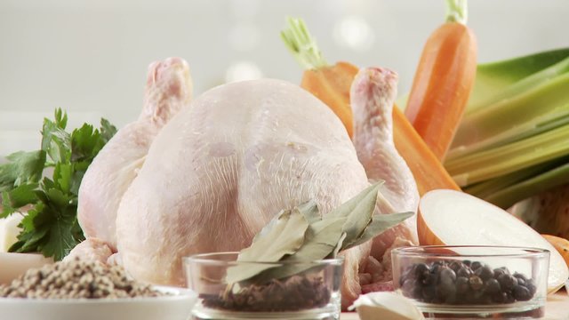 Ingredients for chicken soup: chicken, spices, mirepoix