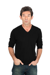 Obraz premium Handsome man doing different expressions in different sets of clothes: bored