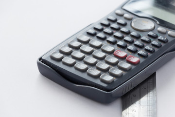 Obraz premium Calculator and Ruler on White Background