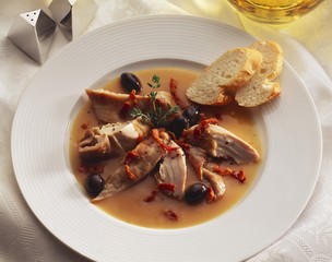 Slices of poularde breast with bacon, black olives & marjoram