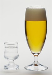 A place setting (a clear schnapps and a Pils)