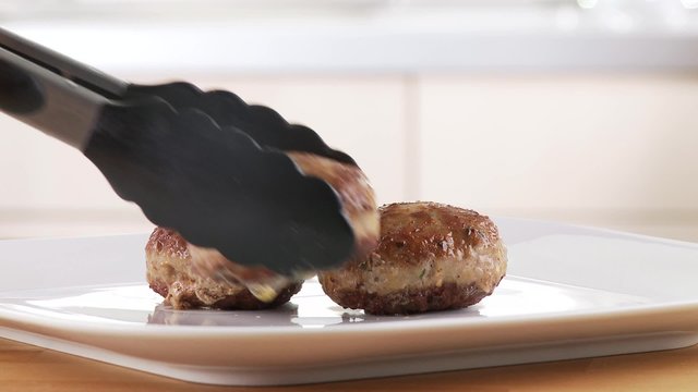 Meatballs being arranged on a plate