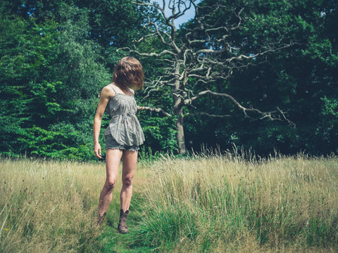 Young woman standing in meadow