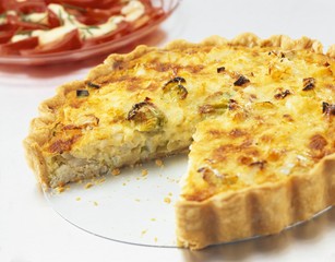 Quiche with leeks, one piece cut out