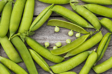 Green peas on wooden table
