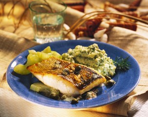 Fish with herb mashed potato, capers and braised cucumber