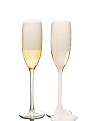 two flute glasses full of champagne