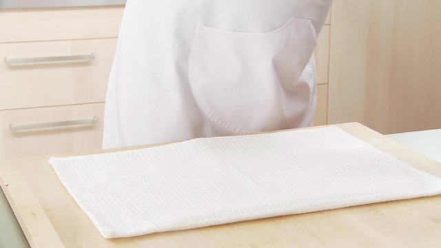 A clean, dry cloth being sprinkled with sugar