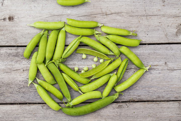 Green peas on wooden table