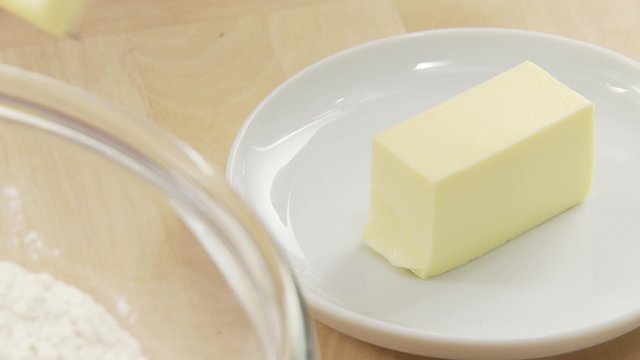 A piece of butter being chopped