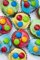 Fototapeta na wymiar Chocolate cupcakes with coloured icing and chocolate beans
