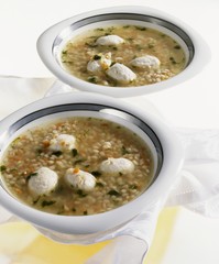 Two bowls of barley soup with zander dumplings