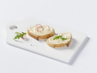 Two slices of bread with cream cheese