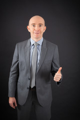 Handsome man doing different expressions in different sets of clothes: thumbs up