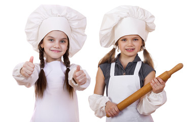 Cooking and people concept - Two Little girls in a white apron