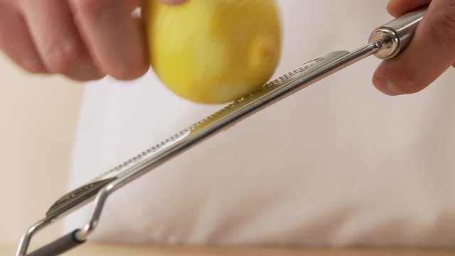 Lemon zest being grated and added to dough ingredients