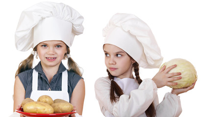 Cooking and people concept - Two Little girls in a white apron